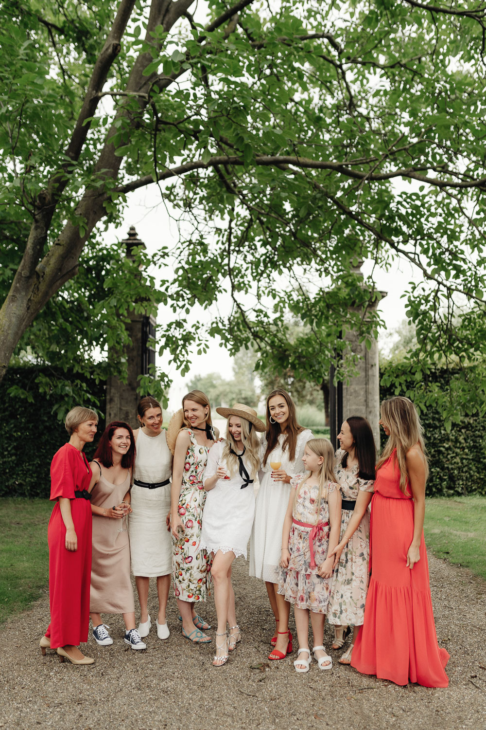 Bridesmaids in white and red dresses are happy and smiling